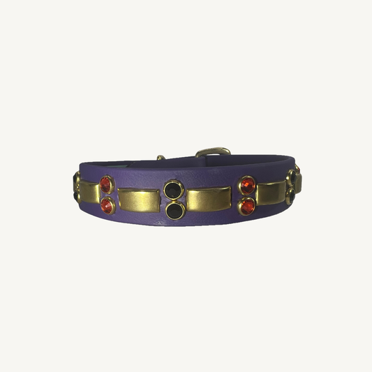 Purple BioThane collar with brass hardware, orange and black crystals on ivory background